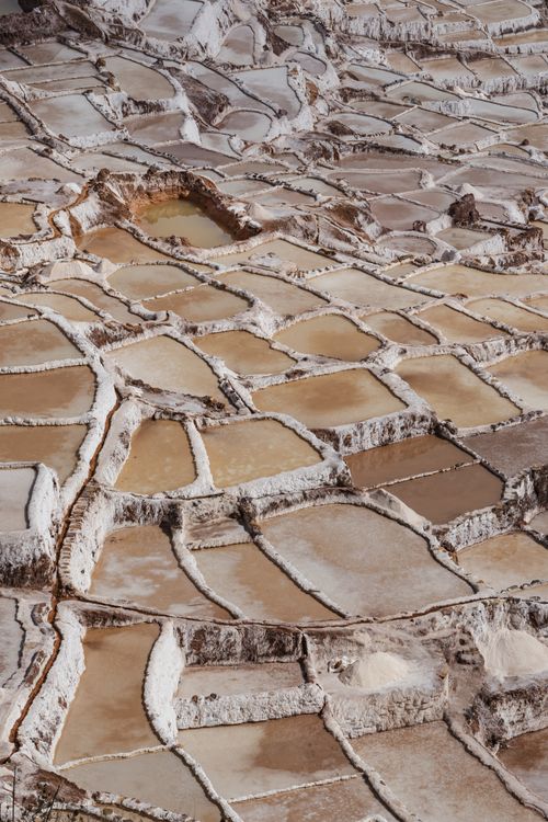 Geometric pattern of salt evaporation ponds at Salineras de Maras showing traditional Andean salt harvesting